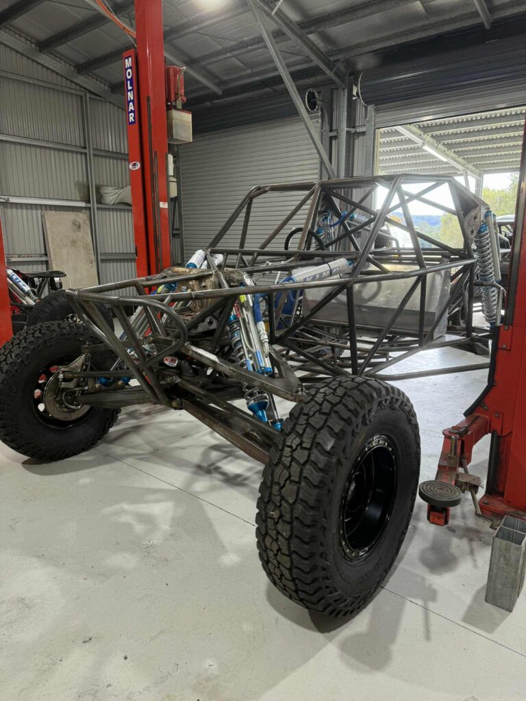 Razorback chassis rolling on the hoist with King coilovers