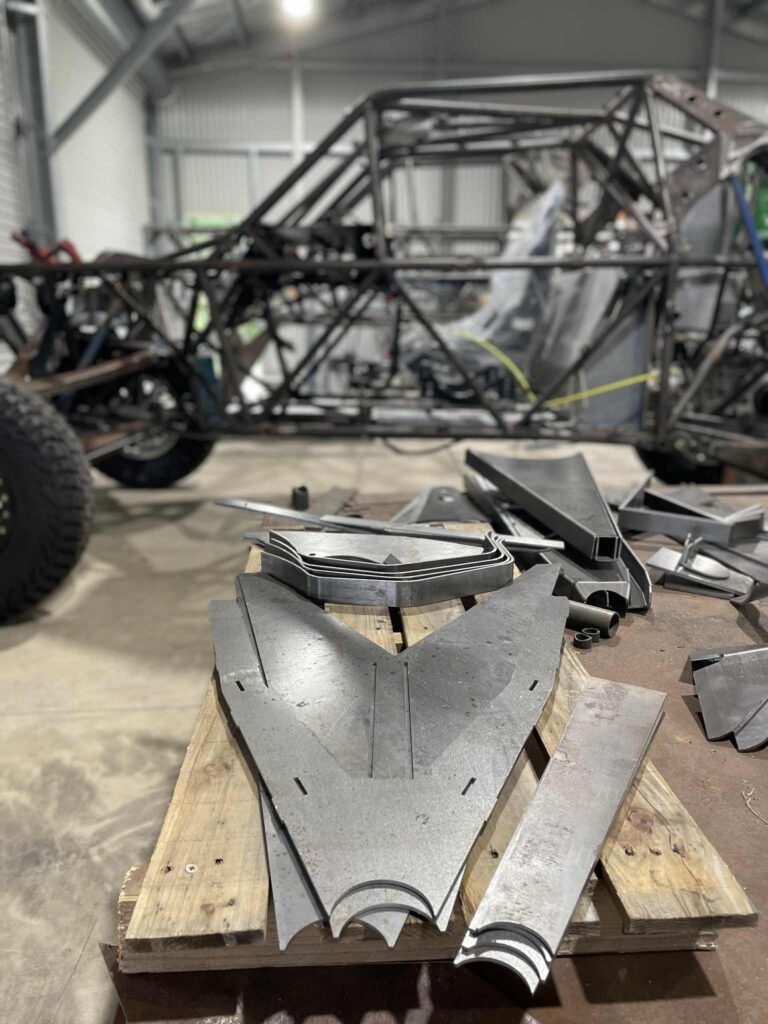 Laser cut steel brackets and plates ready for a Razorback frame build