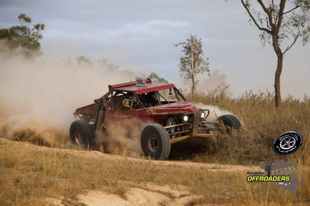 Number 1060 Razorback buggy kicking up dust