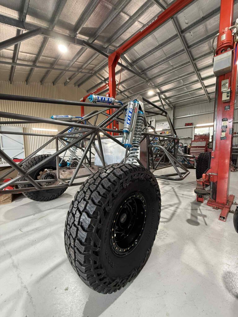 Razorback chassis on the hoist fitted with King shocks and Mickey Thompson tyres